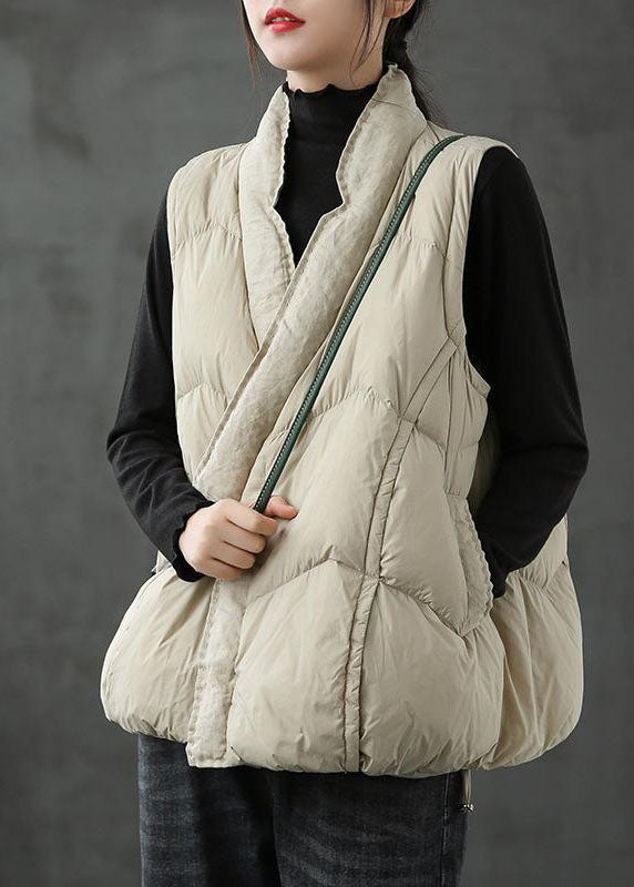 Varm vintervest i beige puffer-stil for kvinner. Ideell for utendørs bruk og casual mote.