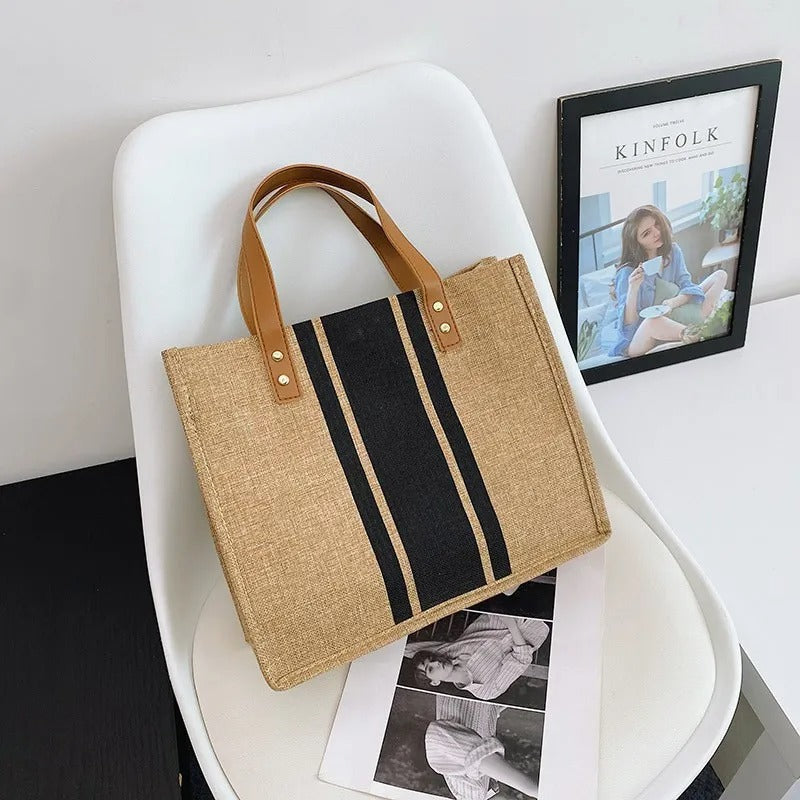 Romslig bøtteveske i lerret med justerbar skulderrem, perfekt som crossbody for kvinner.