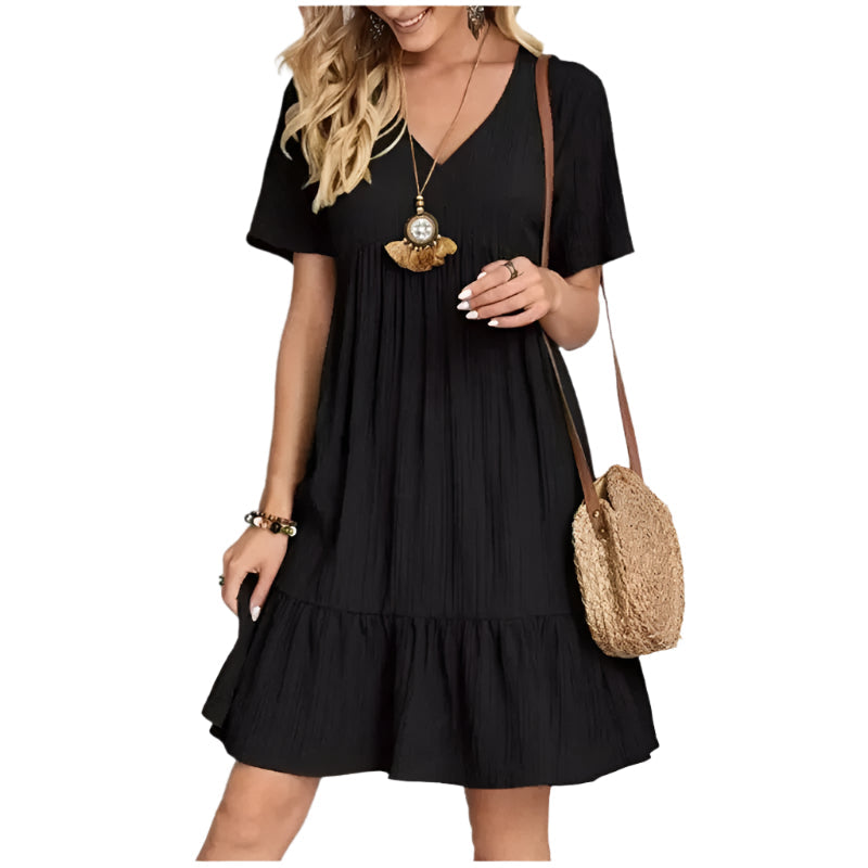 Bakside av Dame Peplum V-hals kjole. Flatterende fit & flare silhuett, elegant og komfortabel damekjole.