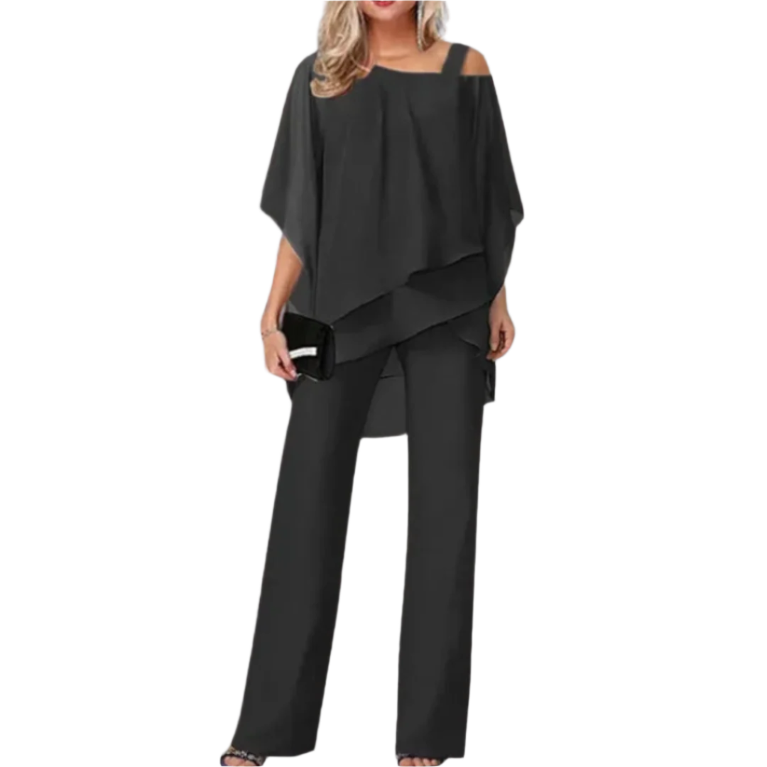 Elegant kvinneensemble med asymmetrisk topp og bred bukse for fest og selskap.