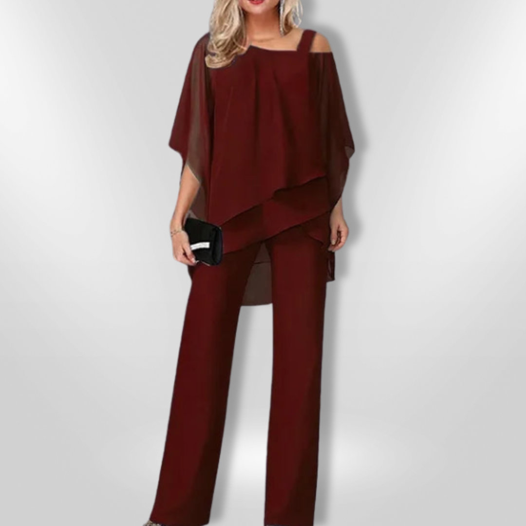 Moderne asymmetrisk kvinnetopp kombinert med elegante, vide bukser for en stilig look.