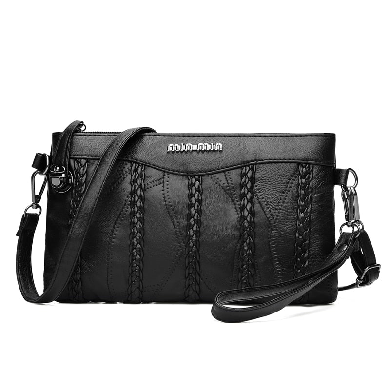 Elegant svart clutchveske for kvinner, med avtagbar crossbody-stropp for fleksibel stil.