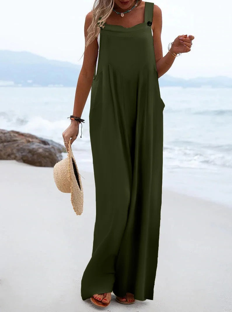 Trendy ensfarget dame jumpsuit med bukseseler og vide ben, en sommerlig motefavoritt.