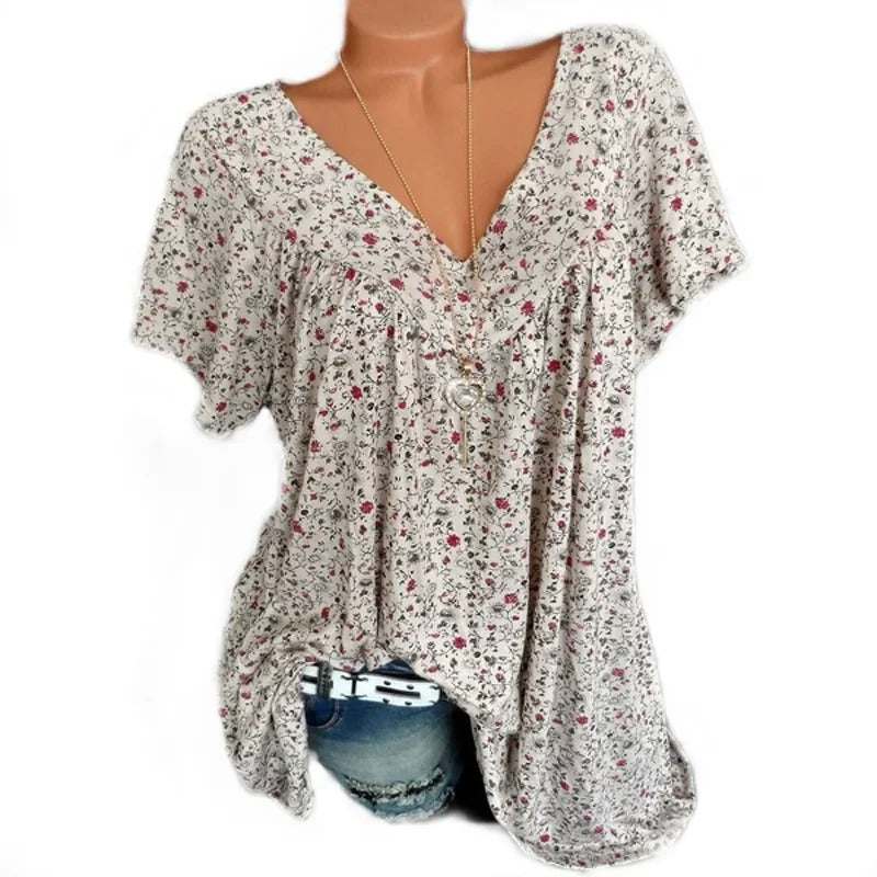 Ledig passform tanktopp for dame, med elegant blomstertrykk og klassisk v-hals design.