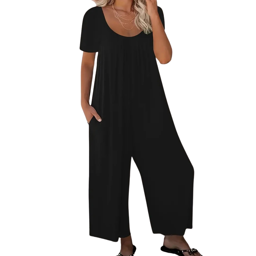 Komfortabel ensfarget jumpsuit for kvinner med vide ben og kortermer, perfekt for sommer og fritid.