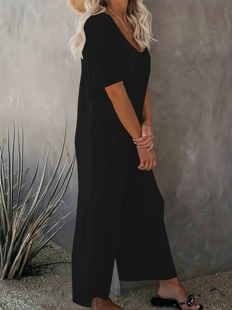 Ensfarget kortermet jumpsuit med vide ben for kvinner, med fokus på komfort og en trendy sommerstil.