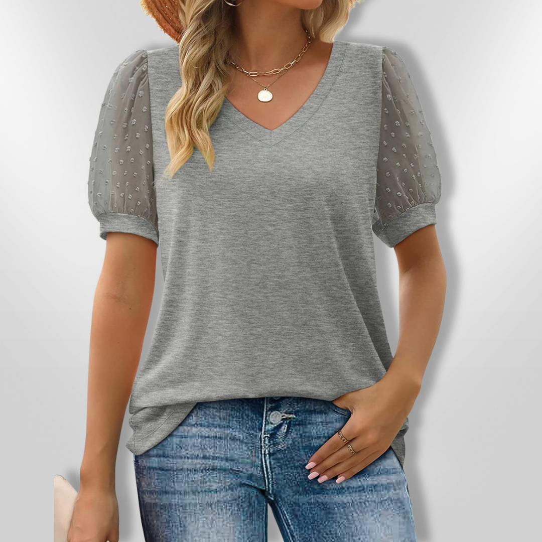 Kvinnebluse med V-hals og puffermer. Elegant, komfortabel dametopp for vår og sommer.