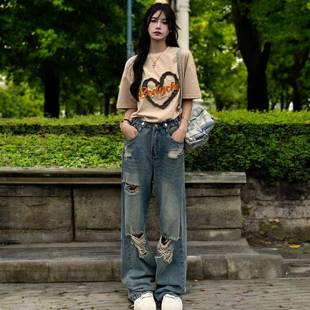 Kvinner vide ben ripped jeans med høy midje og retro stil. Allsidig bukse for trendy gatestil og komfort.