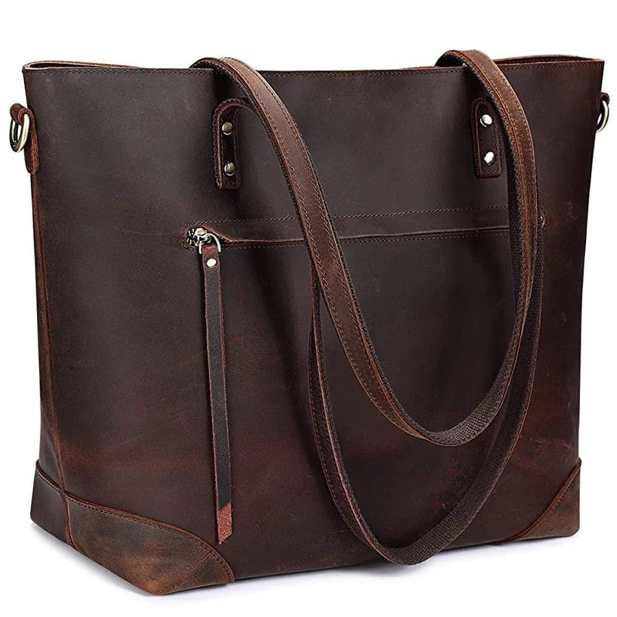 Brun vintage kunstskinn skulderveske/crossbody til dame. Romslig og funksjonell for reise.