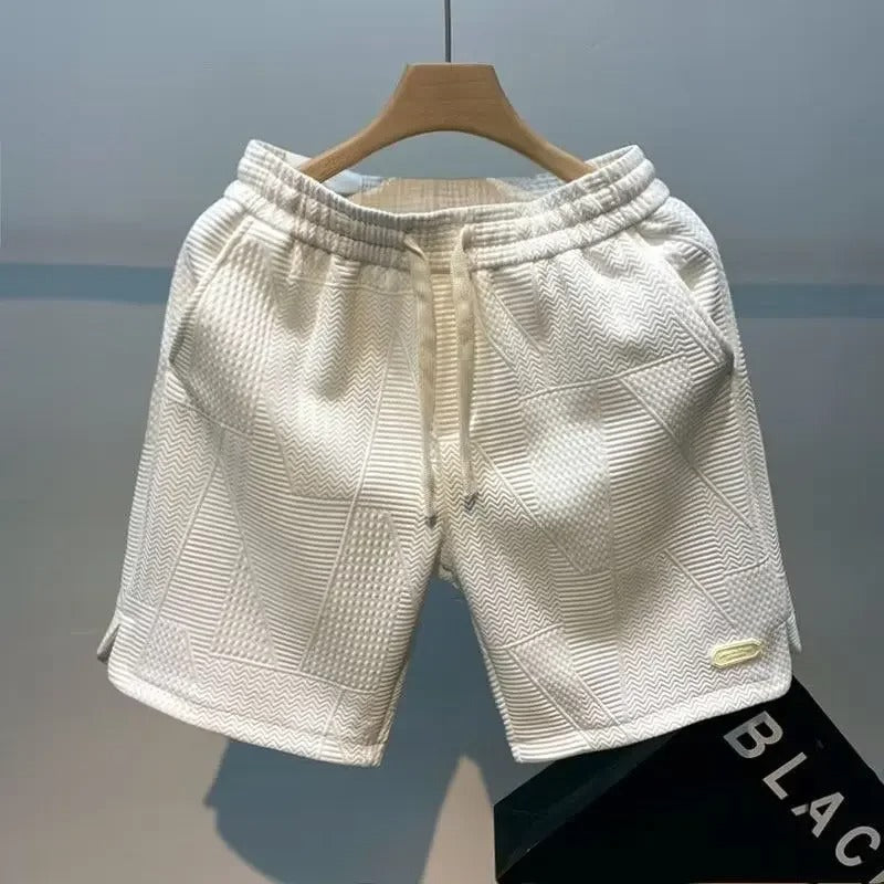 Mann iført allsidige sportsshorts under en aktiv økt. Gir god bevegelsesfrihet og komfort.