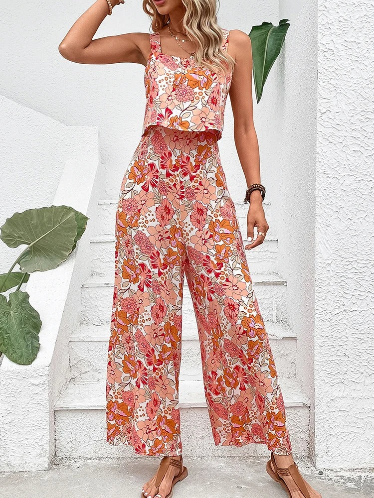 Bakfra av ryggløs blomstret dame jumpsuit, avslører elegant kutt og flytende vide ben.