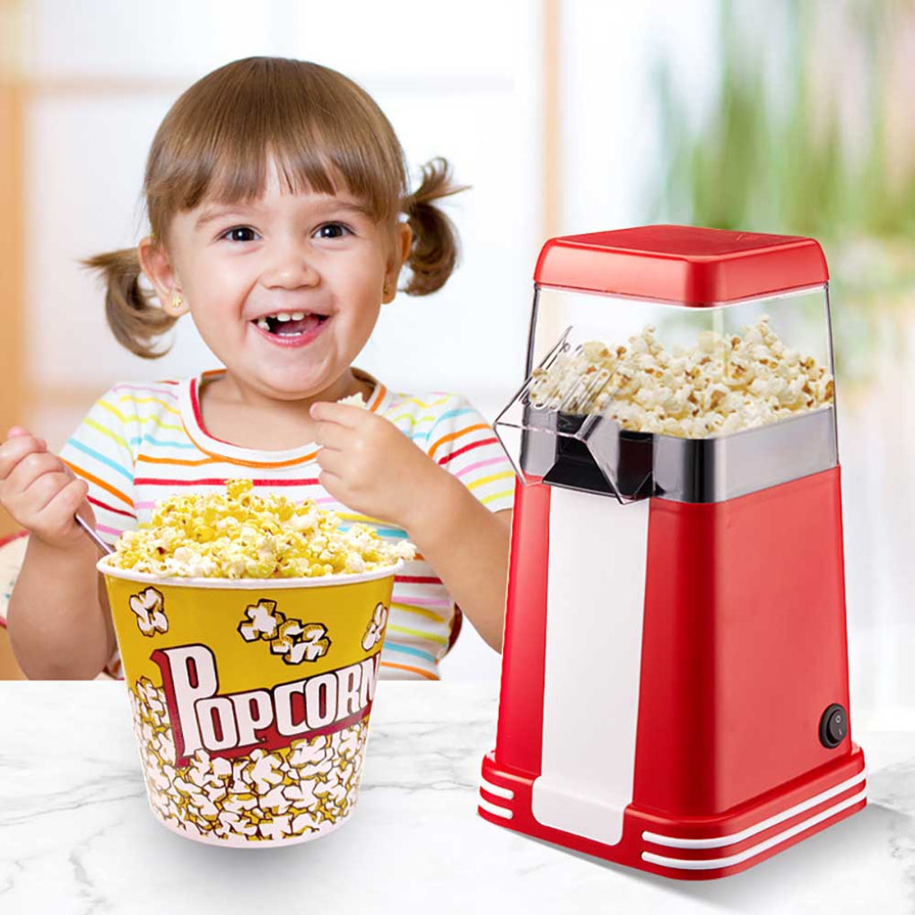 Elektrisk popcornmaskin med retrodesign som lager fersk, varm popcorn for snacks under filmkvelder hjemme.