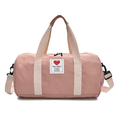 Praktisk sort nylon dame duffelbag med sidelomme, ideell som reiseveske eller treningsbag.