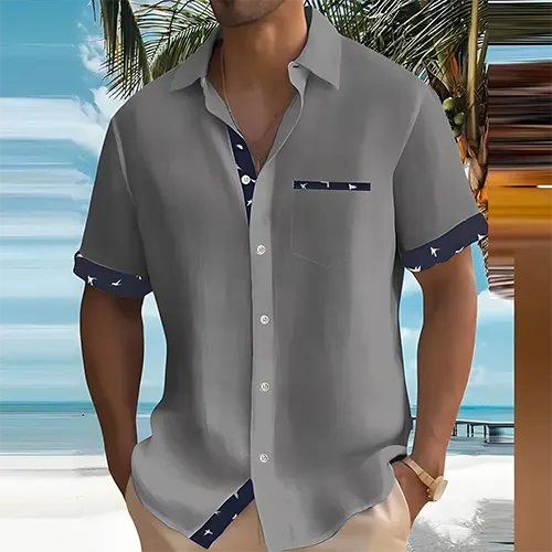 Detalj av pustende kortermet herreskjorte, ideell for varme sommerdager og stilig hverdagsbruk.