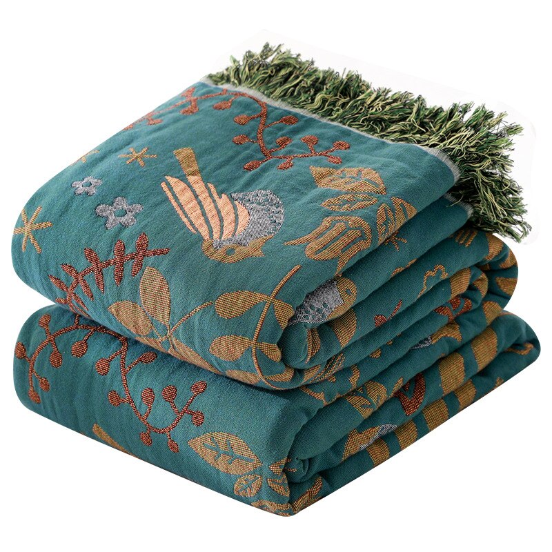 Vendbart vintage pledd i bomull med blomster- og fuglemotiv, dusker. Mykt teppe for sofa eller seng, bohemsk stil.