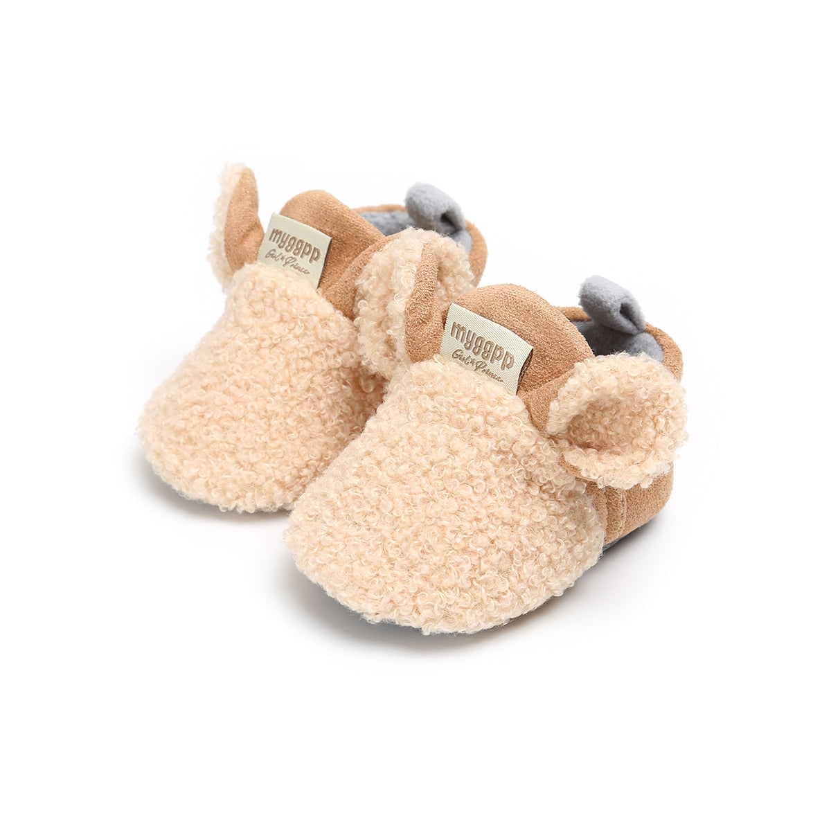 Nærbilde av sålen på babyskoene, sklisikre knotter, lamme-design, trygge første skritt