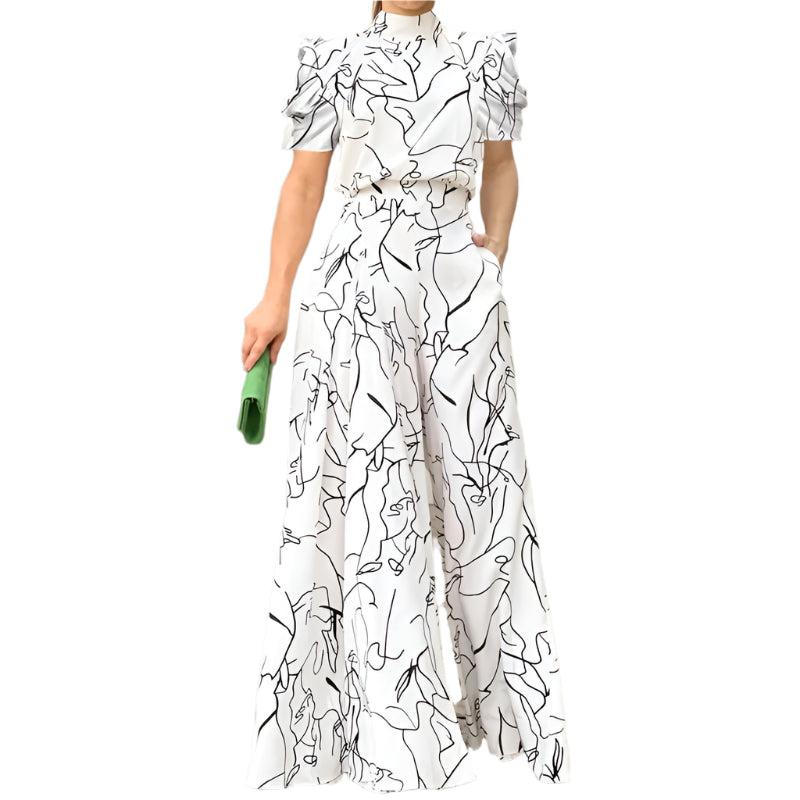 Dame halterneck jumpsuit med vidde ben og unikt kunstprint, perfekt for sommerfest og ferie.