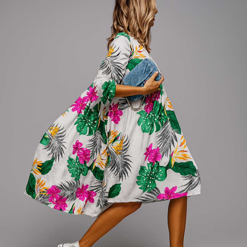 Mønstret damekjole, oversized passform med blomstertrykk, puffermer og midi lengde for komfort.