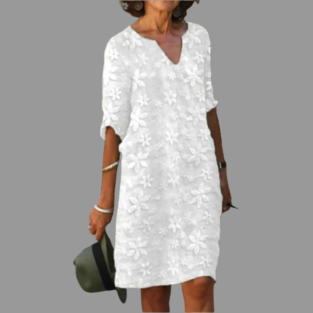 Elegant blomstret midi-kjole for kvinner med V-hals. Perfekt som sommer- eller festkjole i feminin stil.