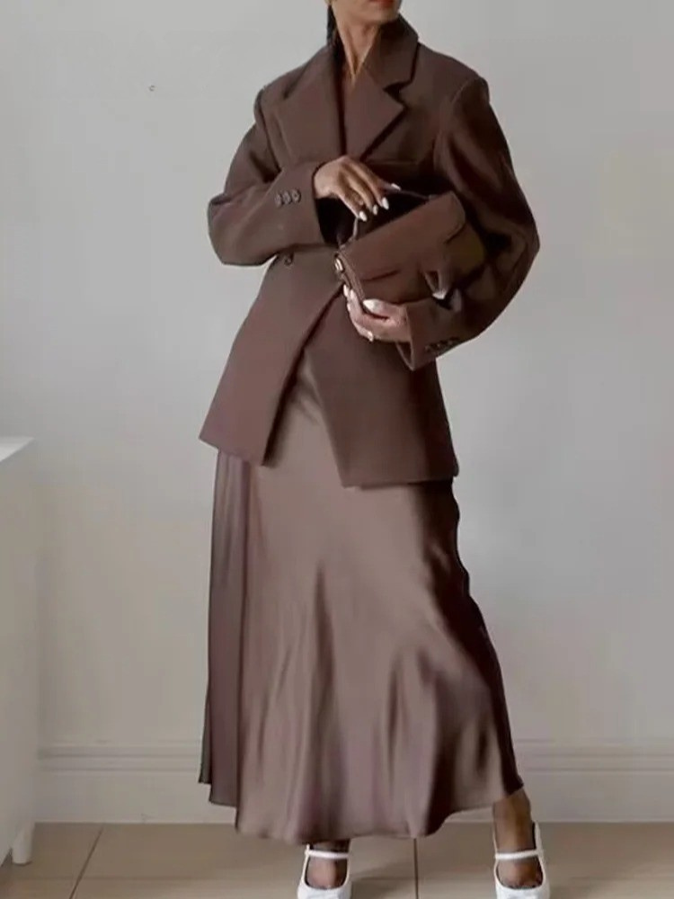 Brun dameblazer med elegant snitt og krage, designet for komfortabel og moteriktig kontorstil.