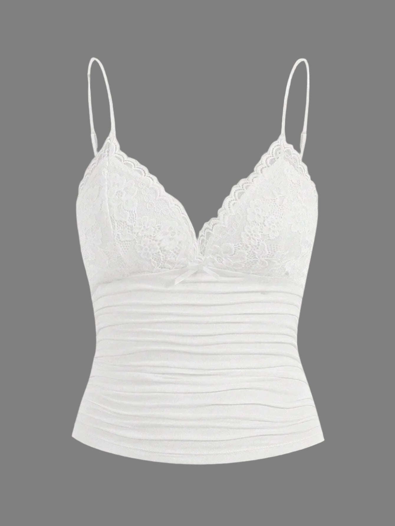 Stilig crop topp i cami-design med delikate blonder og en søt sløyfe. Elegant og justerbar for dame.