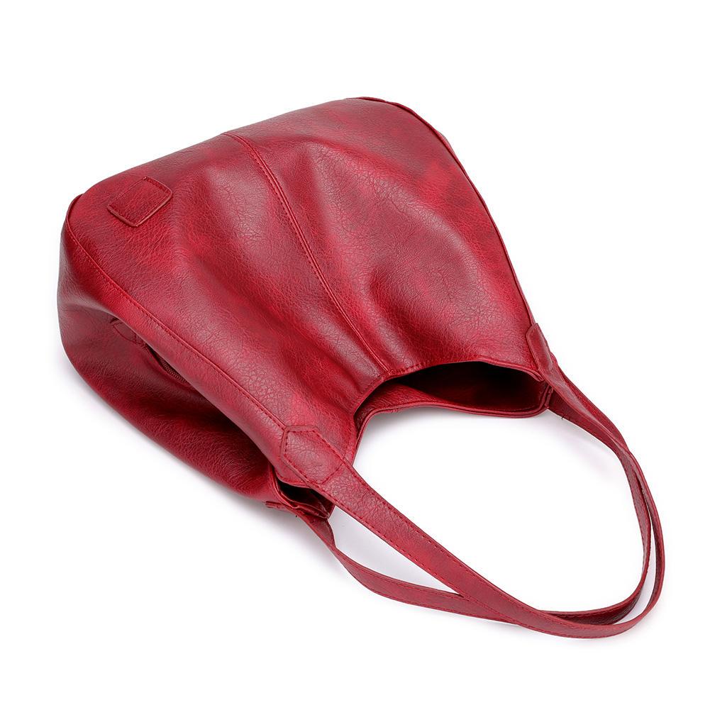 Trendy bøtteveske i kunstskinn, stor nok for laptop og personlige eiendeler.