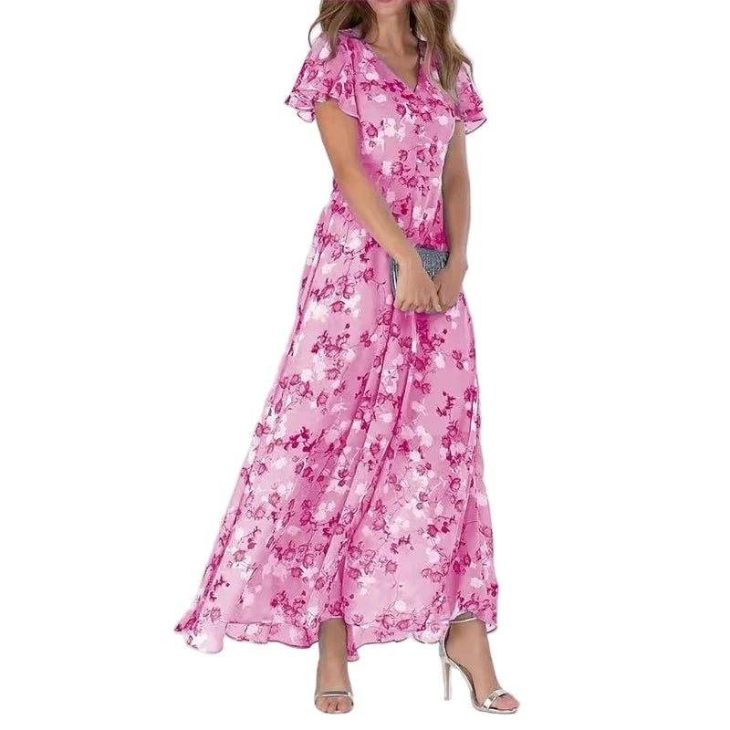 Elegant kvinne maxikjole med fargerikt blomstertrykk og flatterende V-hals, perfekt for sommer og vår.