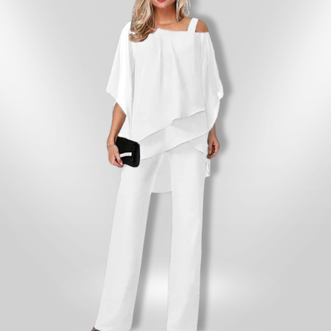 Kvinneantrekk: Stilig asymmetrisk genser og trendy bred bukse, et allsidig ensemble.