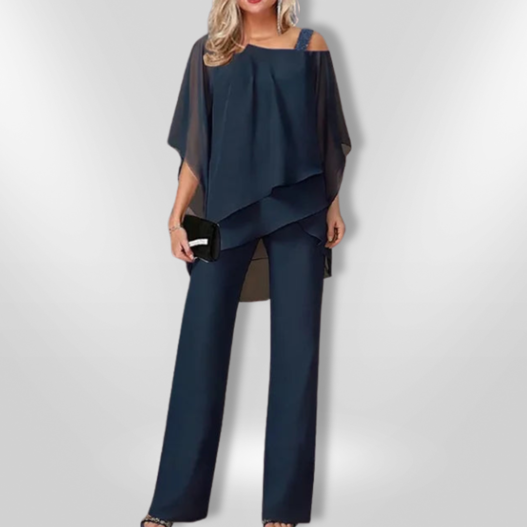 Dame mote: Elegant asymmetrisk topp og bred bukse, et moderne selskapsantrekk.