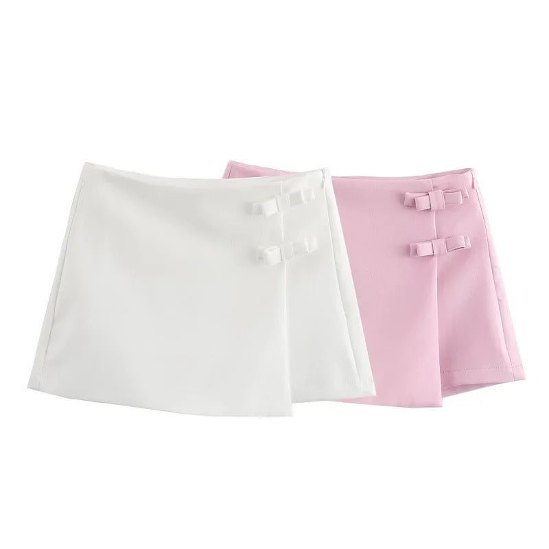 Trendy rosa miniskjørt for dame med fin sløyfedetalj og glidelås. Ideelt for sommer og hverdag.