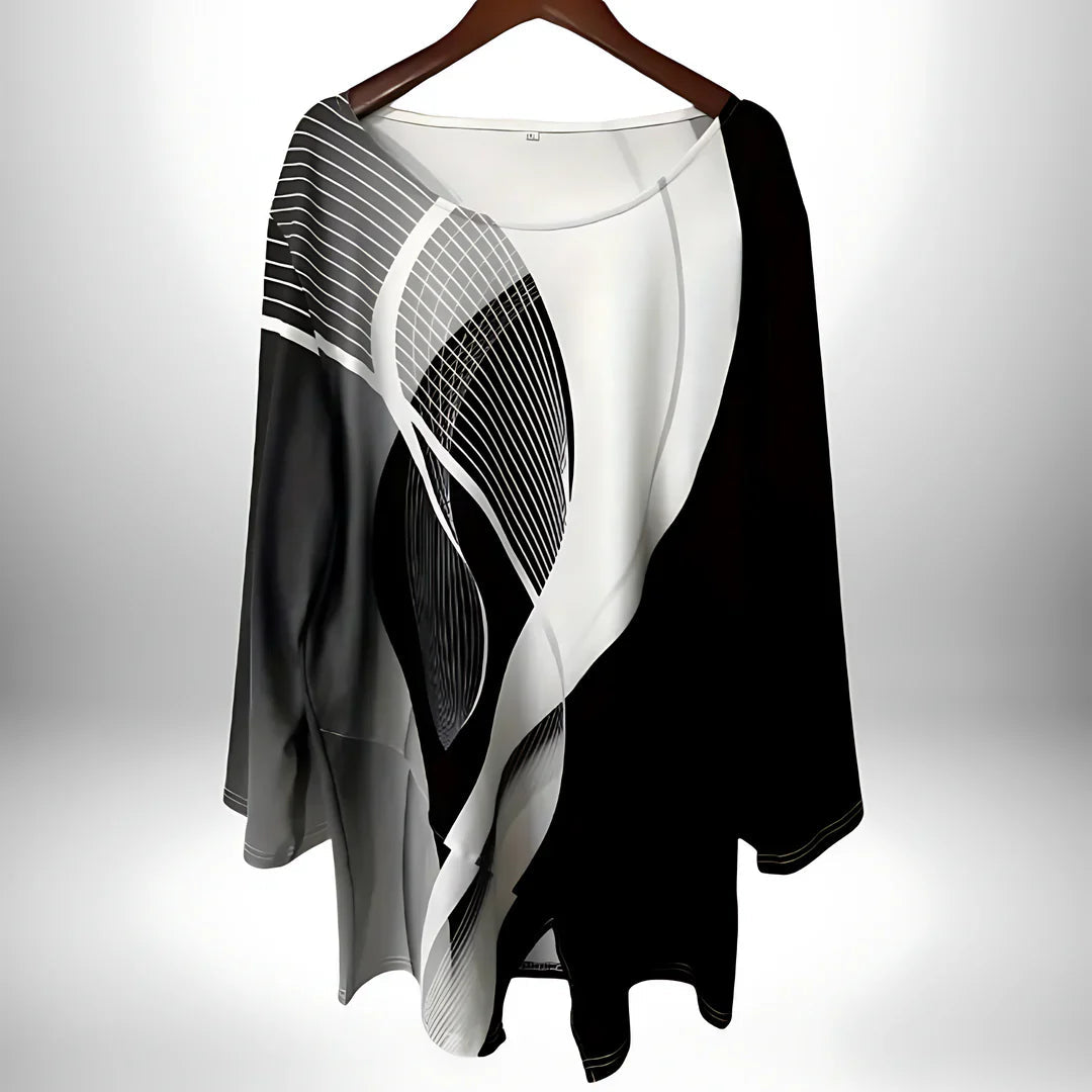 Moderne svart-hvit kvinnebluse med elegant geometrisk mønster og lange ermer for en chic hverdagslook.