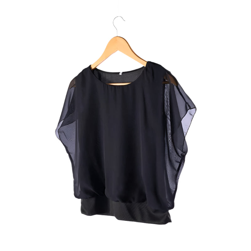 Løs passform volangbluse for kvinner. Elegant design med rund hals og komfortable ermer.