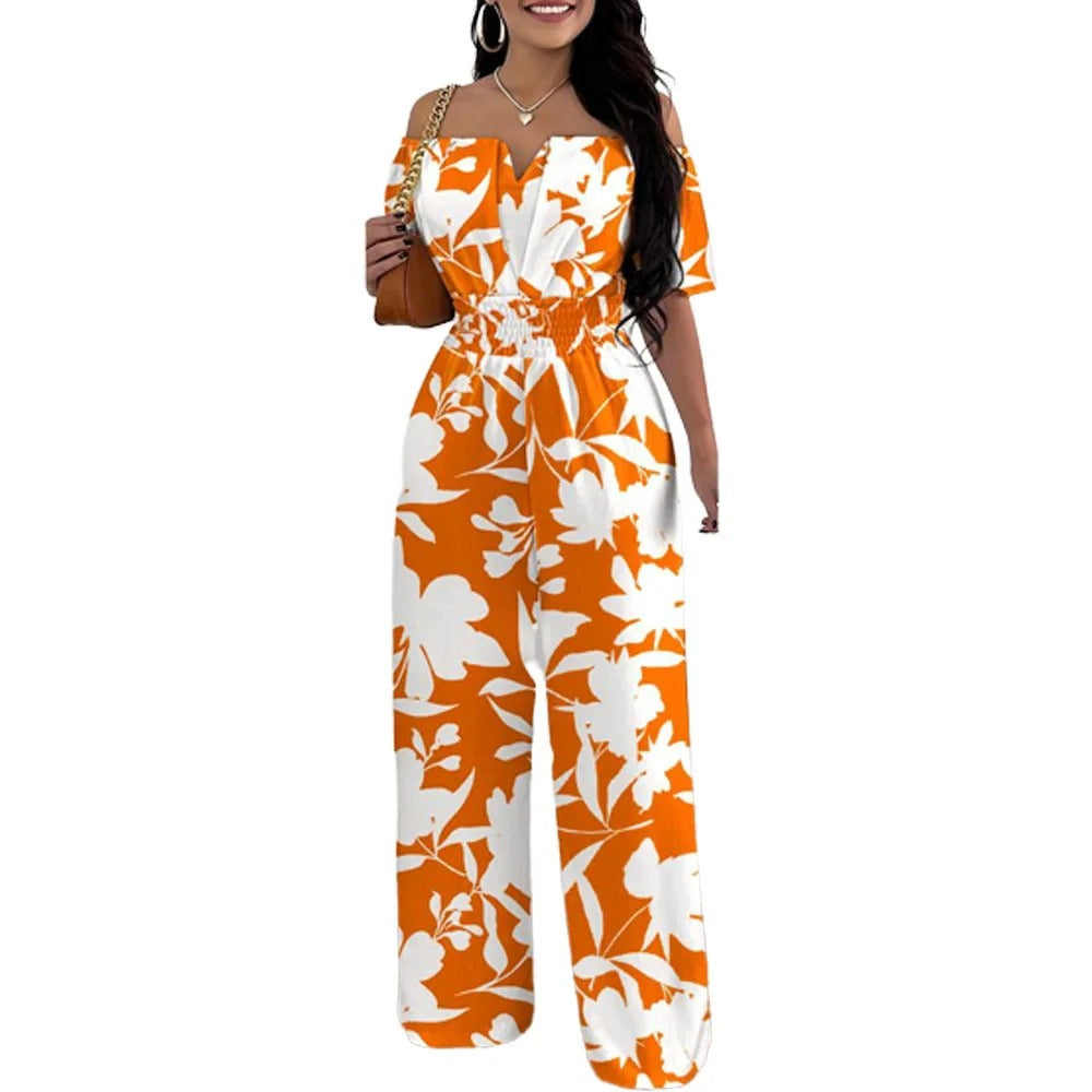 Elegant og komfortabel skulderfri damejumpsuit med trendy trykk og smockmidje, perfekt for sommerdager.