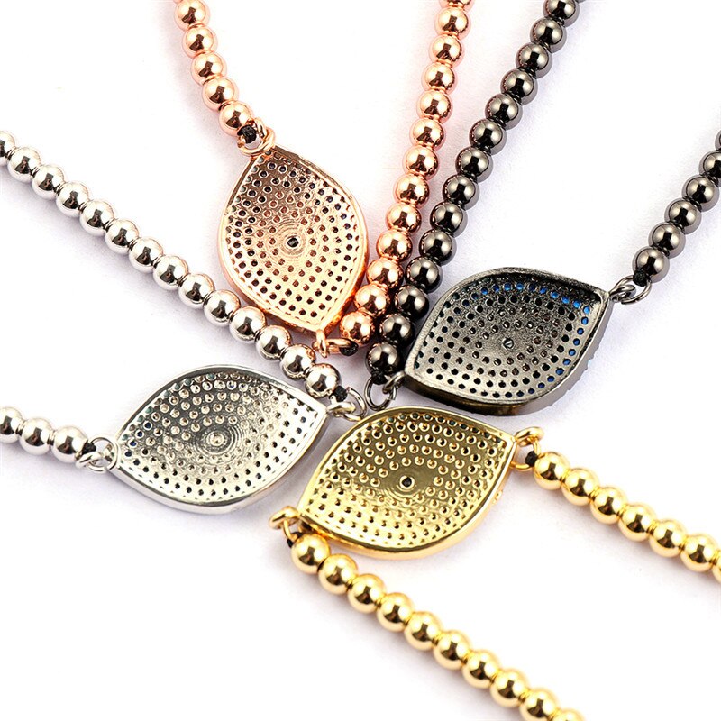 Nærbilde av detaljert gullbelagt onde øye armbånd for dame, med glitrende kubisk zirkonia steiner.
