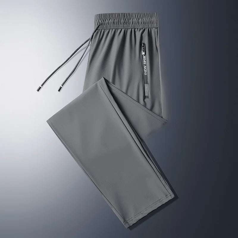 Mann i komfortabel joggebukse med glidelåslommer, perfekt for avslapning eller sporty hverdag.