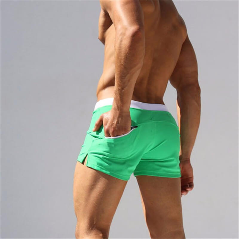 Oransje boardshorts for menn, iøynefallende, hurtigtørkende, for svømmere og strandelskere.