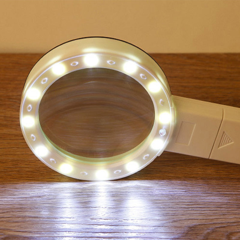 Håndholdt forstørrelsesglass, hvitt, med 30x zoom og LED-lys for inspeksjon av små objekter.