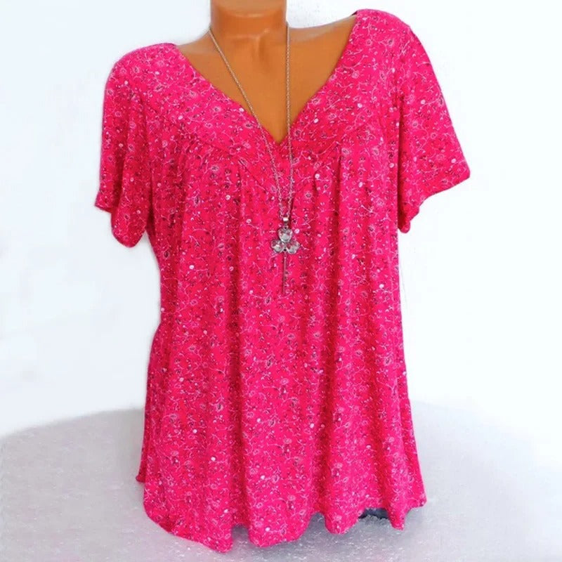 Dame tanktopp med blomstertrykk i bevegelse, fremhever lett stoff og flytende design.