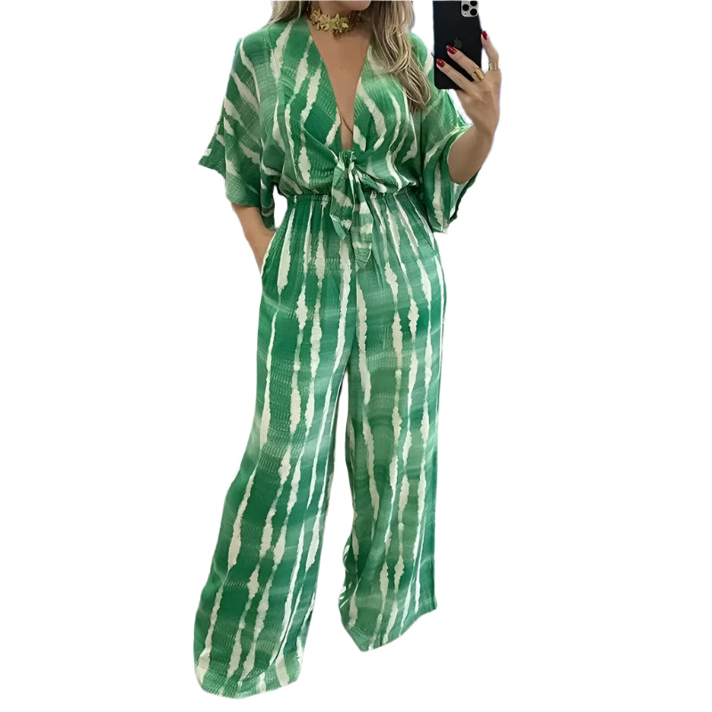 Komfortabel dolman-ermet jumpsuit for kvinner med v-hals og vide ben, perfekt for vår og sommer.