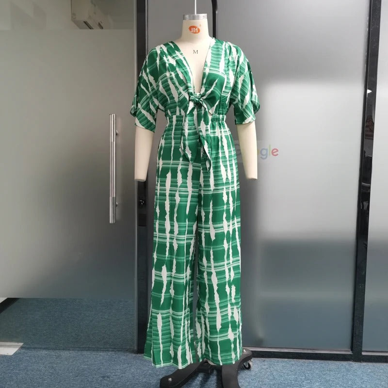 Stilren dolman-ermet jumpsuit med v-hals, vide ben og relaxed fit, elegant dameklær for alle anledninger.