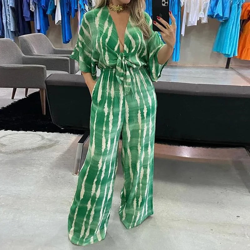 Komfortabel blå dolman-ermet jumpsuit for kvinner, v-hals og vide ben, perfekt for avslappede vår- og sommerdager.
