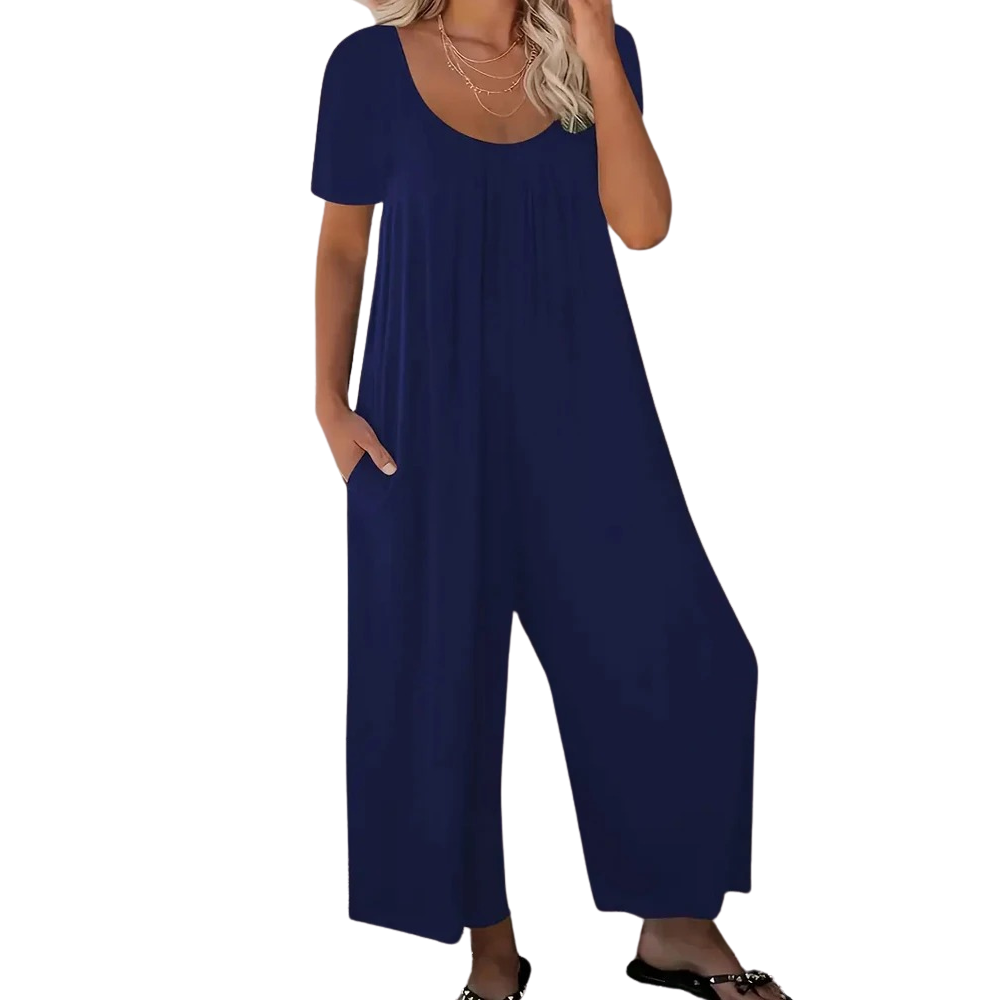Elegant damejumpsuit i ensfarget design, kortermet med vide ben og lommer, ideell for ferie og hverdag.