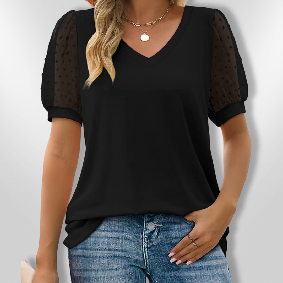 Elegant kvinnebluse med V-hals og trendy puffermer, perfekt for fest eller en stilfull hverdag.