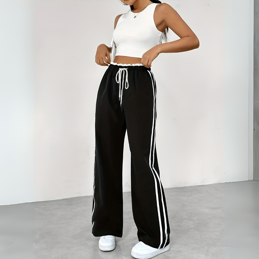 Sporty vide bukser i grå for kvinner, med høy midje design. Perfekte casual bukser for enhver trendbevisst dame.
