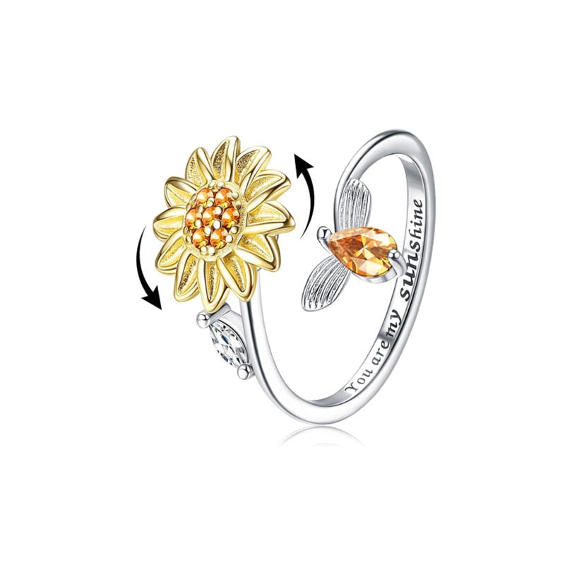 Detaljert bilde av kvinne som spinner en solsikke angstring. Anti-stress fidget ring for ro og fokus.
