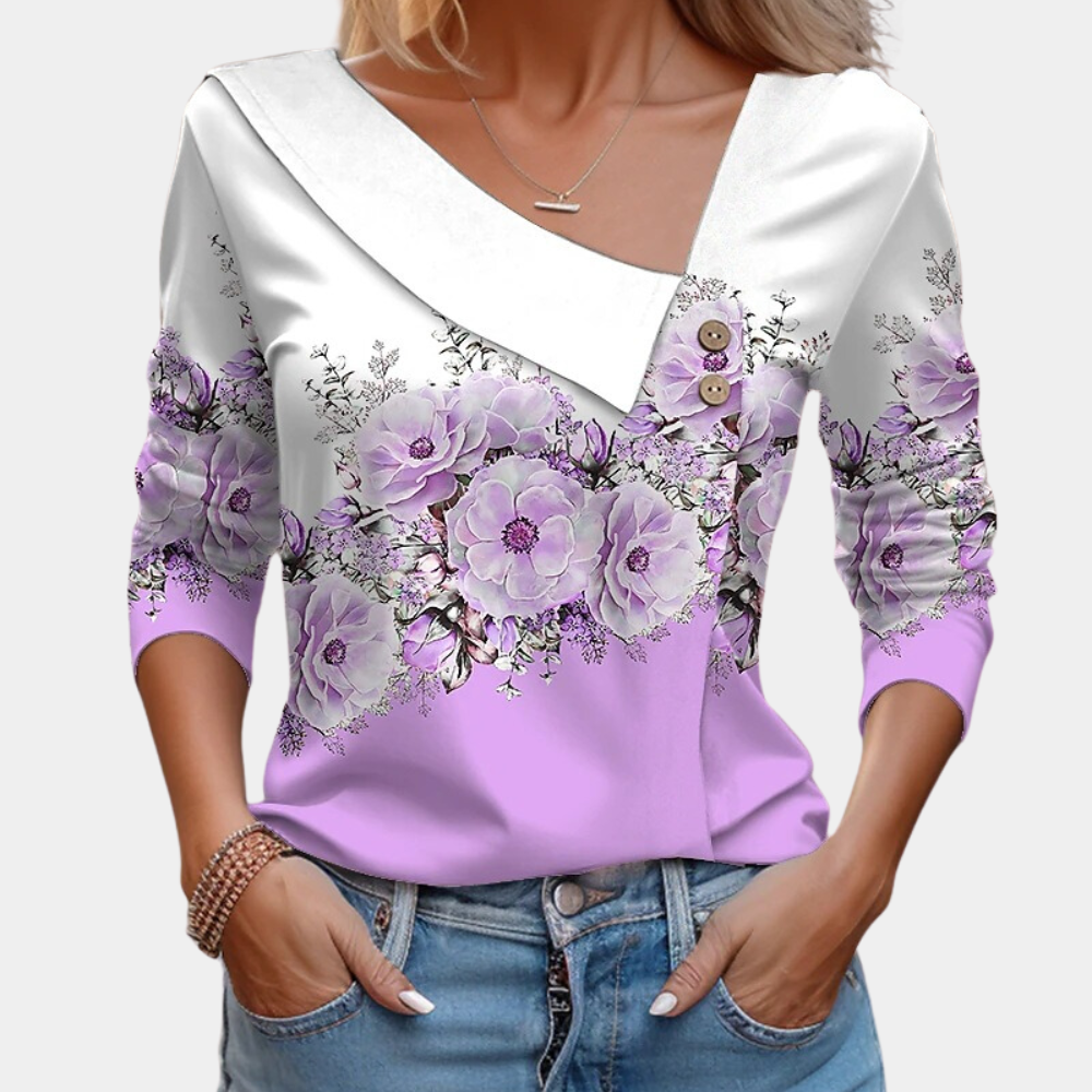 Feminin vår-/sommerbluse med livlig blomsterprint, langermet overdel som gir et friskt uttrykk.