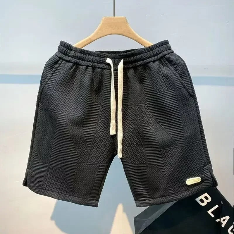 Komfortable menns sportsshorts i pustende stoff, ideell for løping, gym og sommerklær.