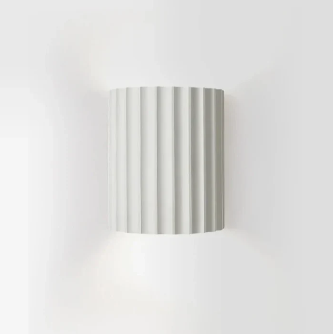 Skandinavisk, minimalistisk vegglampe som gir et moderne uttrykk og innbydende stemningslys.
