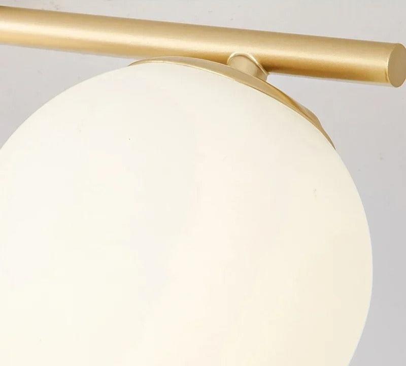 Taklampe med hvit glasskule, svarte detaljer, gullfarget. Moderne LED-belysning for stue.