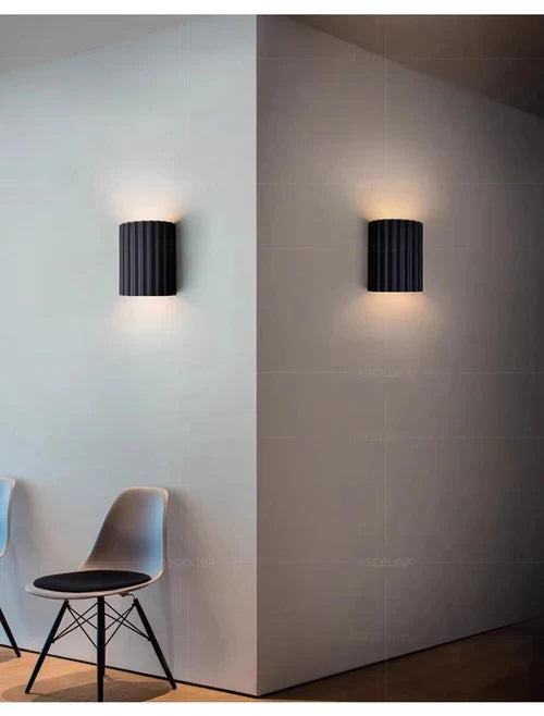 Moderne vegglampe med unik kunstnerisk design, skaper varm atmosfære i interiøret.